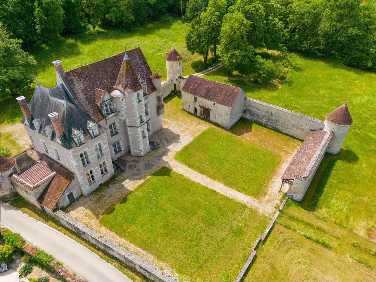 Aerial view of the Manor, its courtyard, outbuildings and meadows